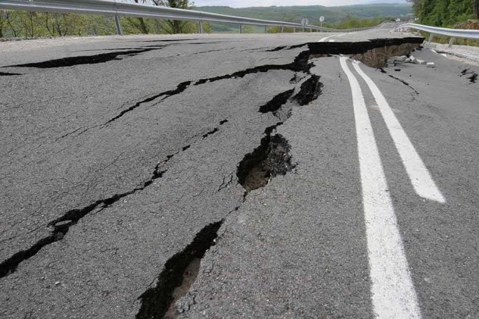 shutterstock_1044748162 Asphalt road with deep cracks and collapse