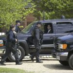 Feds Raid STALKER’S Home — What They FOUND! security officers walk past black SUVs during operation