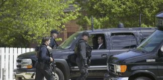 Feds Raid STALKER’S Home — What They FOUND! security officers walk past black SUVs during operation