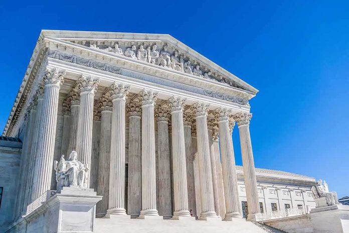 Supreme Court building with tall marble columns under a clear blue sky