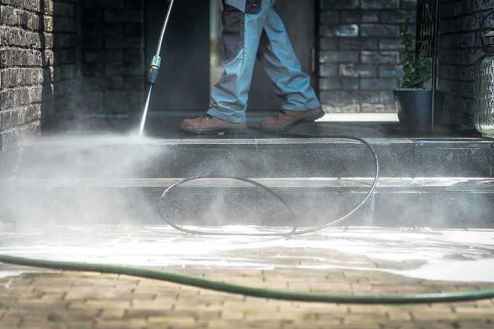 shutterstock_1146089972 Worker pressure washing outdoor steps