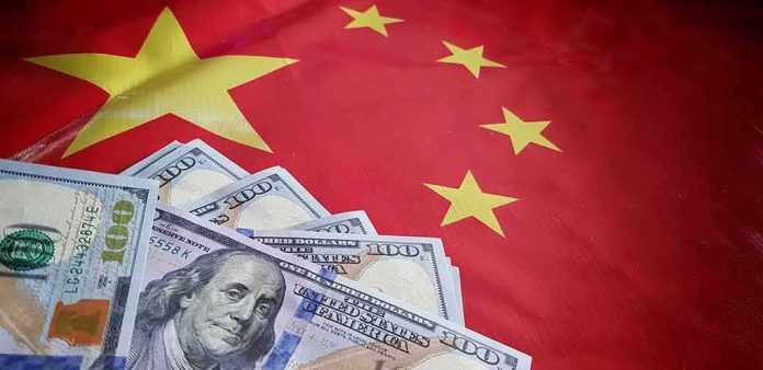 shutterstock_1177663942 US dollars on Chinese flag