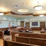 Star’s Killing TWIST Stuns COURTROOM Empty courtroom with wooden benches and judge's bench