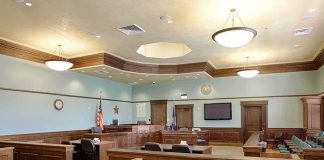 Star’s Killing TWIST Stuns COURTROOM Empty courtroom with wooden benches and judge's bench