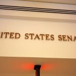 Senator EXPOSES ‘Danger’ Inside Congress Sign displaying United States Senate in a government building