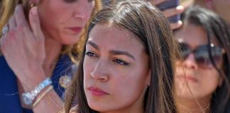 STUNNING — AOC REJECTED — LEFT Civil WAR Erupts woman in red top at an outdoor event