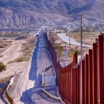 Judge GREENLIGHTS Controversial Border Push — MAJOR Trump WIN Border fence running through desert landscape