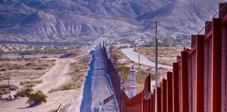Judge GREENLIGHTS Controversial Border Push — MAJOR Trump WIN Border fence running through desert landscape