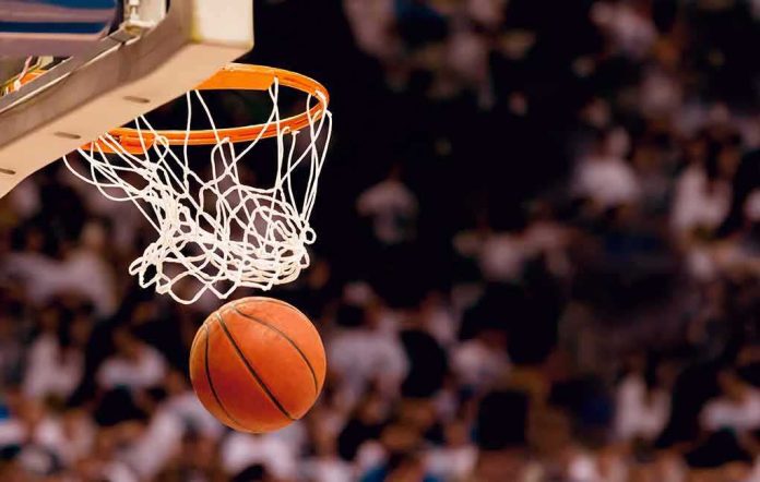 shutterstock_173318291 Basketball dropping through a hoop