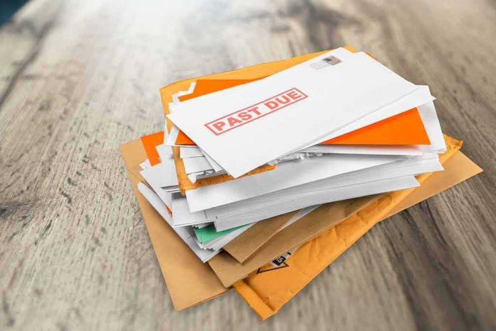 shutterstock_1810991899 Stack of mail with past due notice on top
