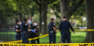 Daylight BRUTAL Killing Shocks Atlanta crime scene tape with police officers in a park