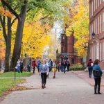 Celebrity PROFESSOR Found DEAD — ICON College SCRAMBLES Students walking through a leafy campus path in autumn