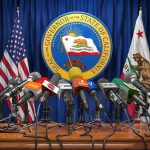 Islamic HOLIDAYS Added to State’s CLOSURE LIST Press microphones at a podium before California governor seal
