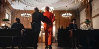 Lottery Sting TWIST — PROTECTOR Turns PREDATOR Prisoner in orange jumpsuit escorted by officer in a courtroom