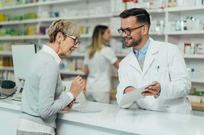 shutterstock_2089997875 Pharmacist assists customer at pharmacy counter