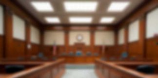 Judge OUSTED — Now What EXPLODES? Empty courtroom with wooden benches and judge's bench