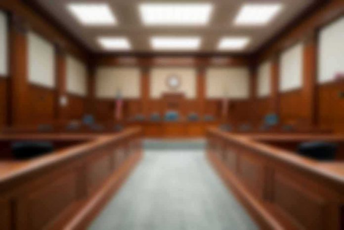 Empty courtroom with wooden benches and judge's bench