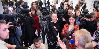 Beloved Star GONE At 36 A crowded press conference with journalists and cameras surrounding a speaker