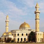 BRAWL Erupts — ISLAMIC EXPANSION Plan Still Passes Mosque with golden dome and two tall minarets under a partly cloudy sky