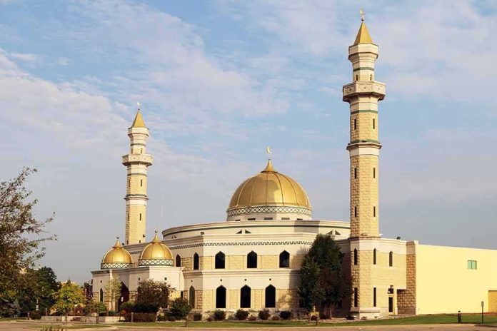 shutterstock_312777998 Mosque with golden dome and two tall minarets under a partly cloudy sky