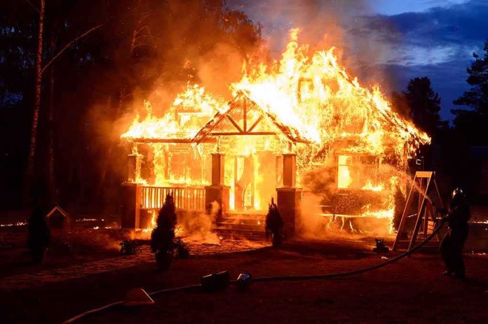house engulfed in flames at night