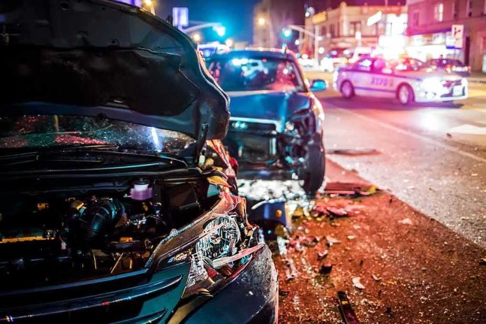 shutterstock_607907531 Wrecked cars at night crash scene with police lights