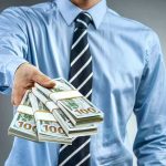 Big Donors Turbocharge Rebel Party Person in business attire offering bundles of US dollar bills