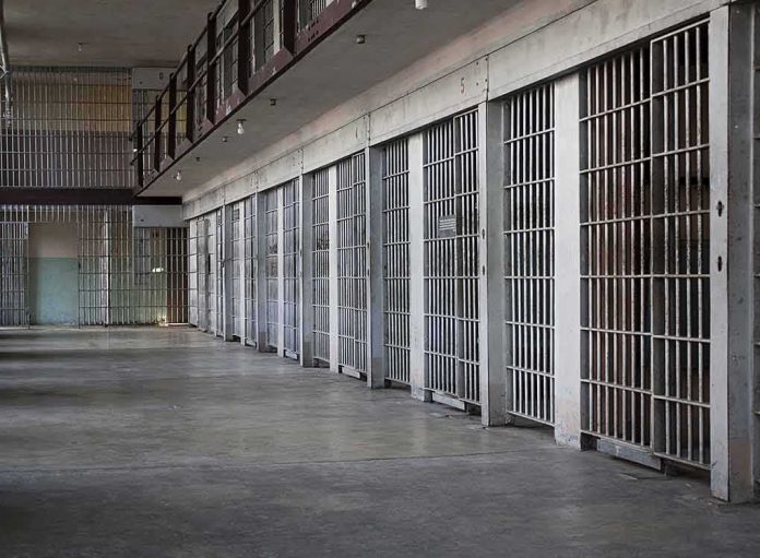 shutterstock_100994692 prison cell block with metal barred doors