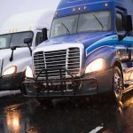 A Trucker Got Stopped For SPEEDING — Then The COP Ran His NAME Two semi trucks driving side by side on a wet highway