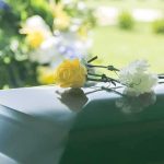 Famed Artist Is Dead At 88 — The Fight Over Him Started YEARS Ago Yellow rose and white carnation on a green casket