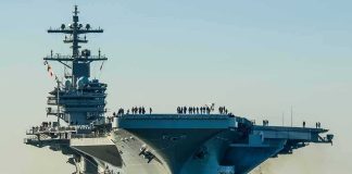 How ONE HIT Can “KILL” a $13B Carrier Aircraft carrier guided by tugboats in a harbor