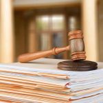 They Heard 43 Witnesses — And Charged NO ONE judge's gavel resting on a stack of case files
