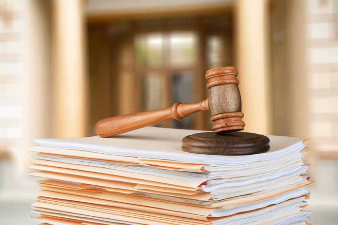 shutterstock_1025580877 judge's gavel resting on a stack of case files