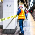 It Lay Steps From A Busy Subway Stop For DAYS. Nobody NOTICED Transit worker on a subway platform behind caution tape