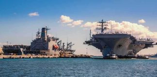 90 Sailors Came Home From Sea — No Cars, Just The BILL Aircraft carrier and support ships docked at a naval harbor