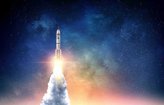 shutterstock_1113907334 Rocket launching into starry night sky