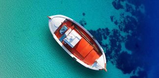Four Pilots Went Fishing — The Air Force Took Their CATCH Small boat floating over clear turquoise water