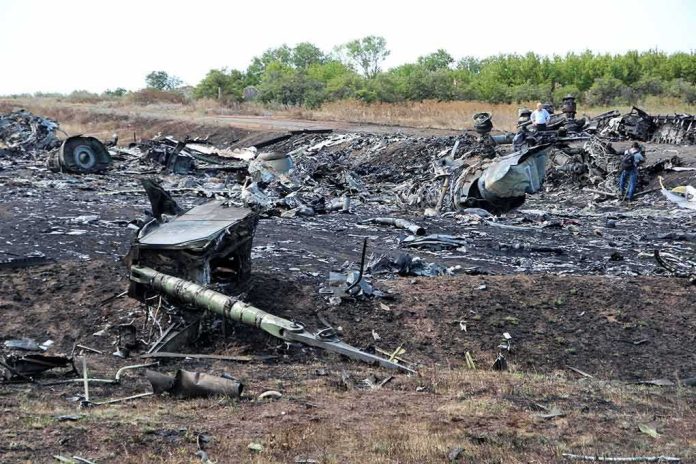 Aircraft wreckage scattered across a scorched rural field
