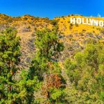 Hollywood Cash FLOODS Senate Battle Hollywood Sign on a sunny hillside above green trees
