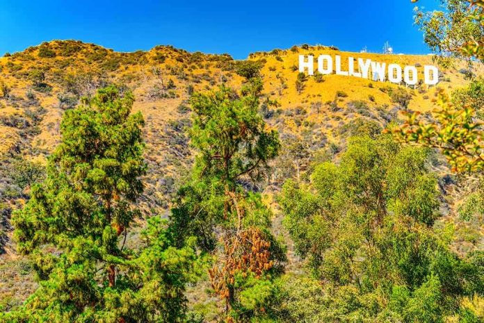 shutterstock_1356693626 Hollywood Sign on a sunny hillside above green trees