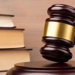A Reporter Died In His Hotel Room — A Jury Just Ruled On The WOMAN Judge's gavel with gold band beside stacked law books