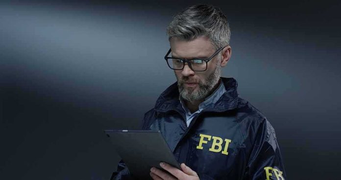 FBI agent with glasses using a tablet