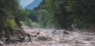 Raging Wall Of Water TRAPS HIKERS Flooded river gorge with fast muddy water and rocks