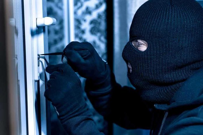 shutterstock_1751741492-1 Masked person picking a door lock