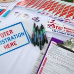 God’s Gender? Texas Democrat IGNITES Intense Debate Voter registration table with forms, pens, and informational materials
