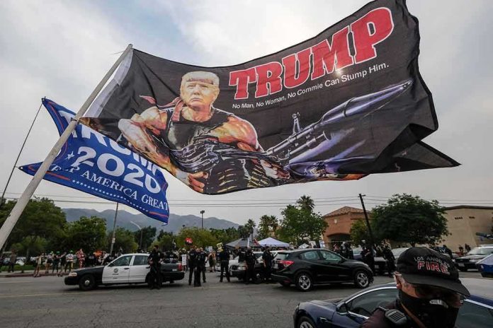 shutterstock_1800439882 Large political flag over street protest with police and cars below