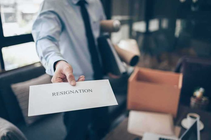 employee handing over a resignation letter