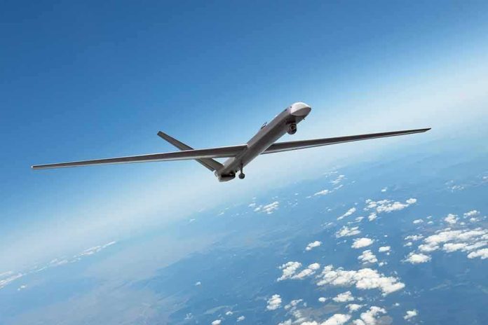 shutterstock_2138419037 Unmanned aerial drone flying high above clouds