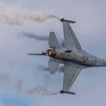 Two F-16s Lost In Five Days — And This Base Has A HISTORY Fighter jet banking with afterburner against a cloudy sky