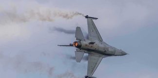 Two F-16s Lost In Five Days — And This Base Has A HISTORY Fighter jet banking with afterburner against a cloudy sky